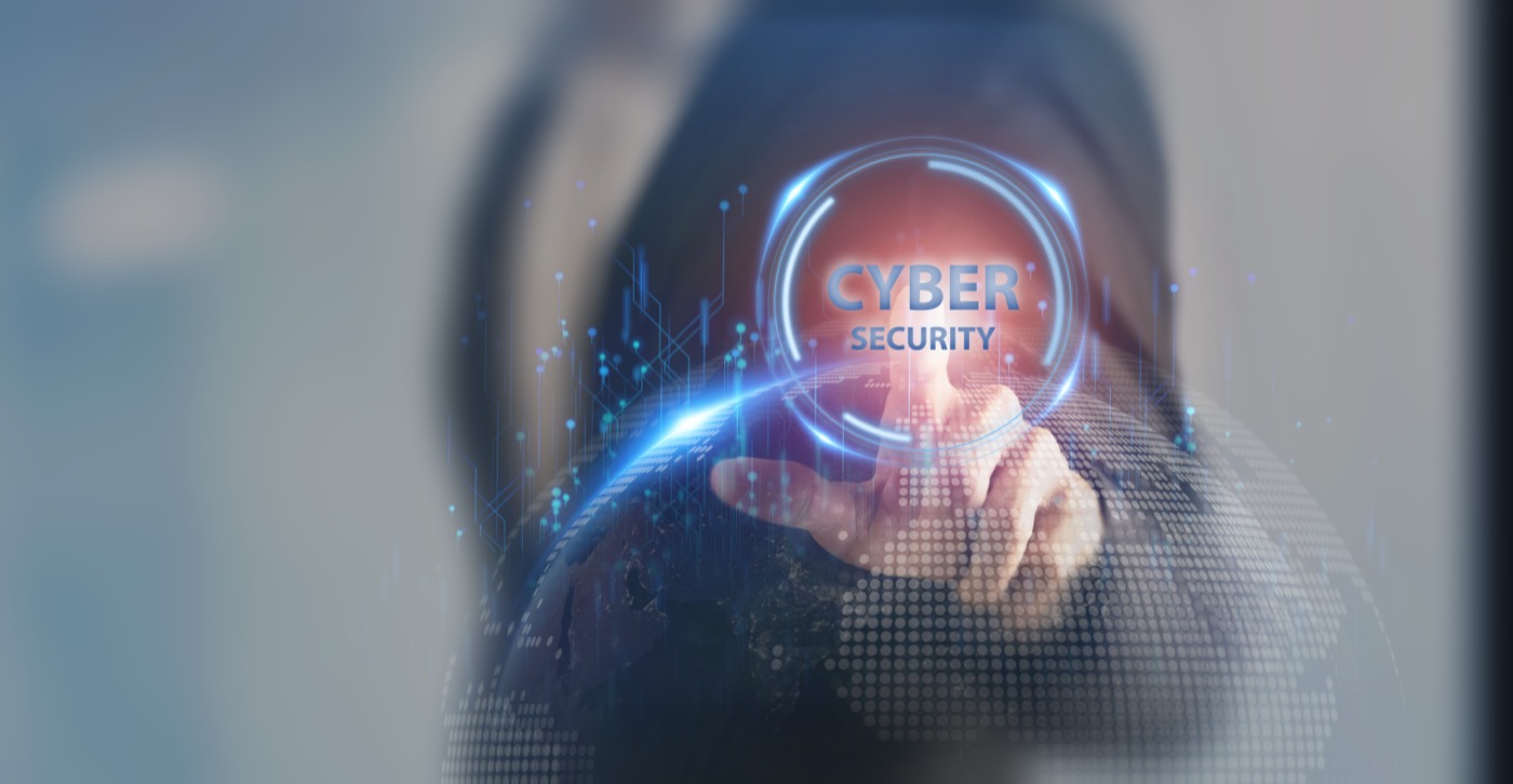Cybersecurity — reaching toward a glowing cyber security shield interface