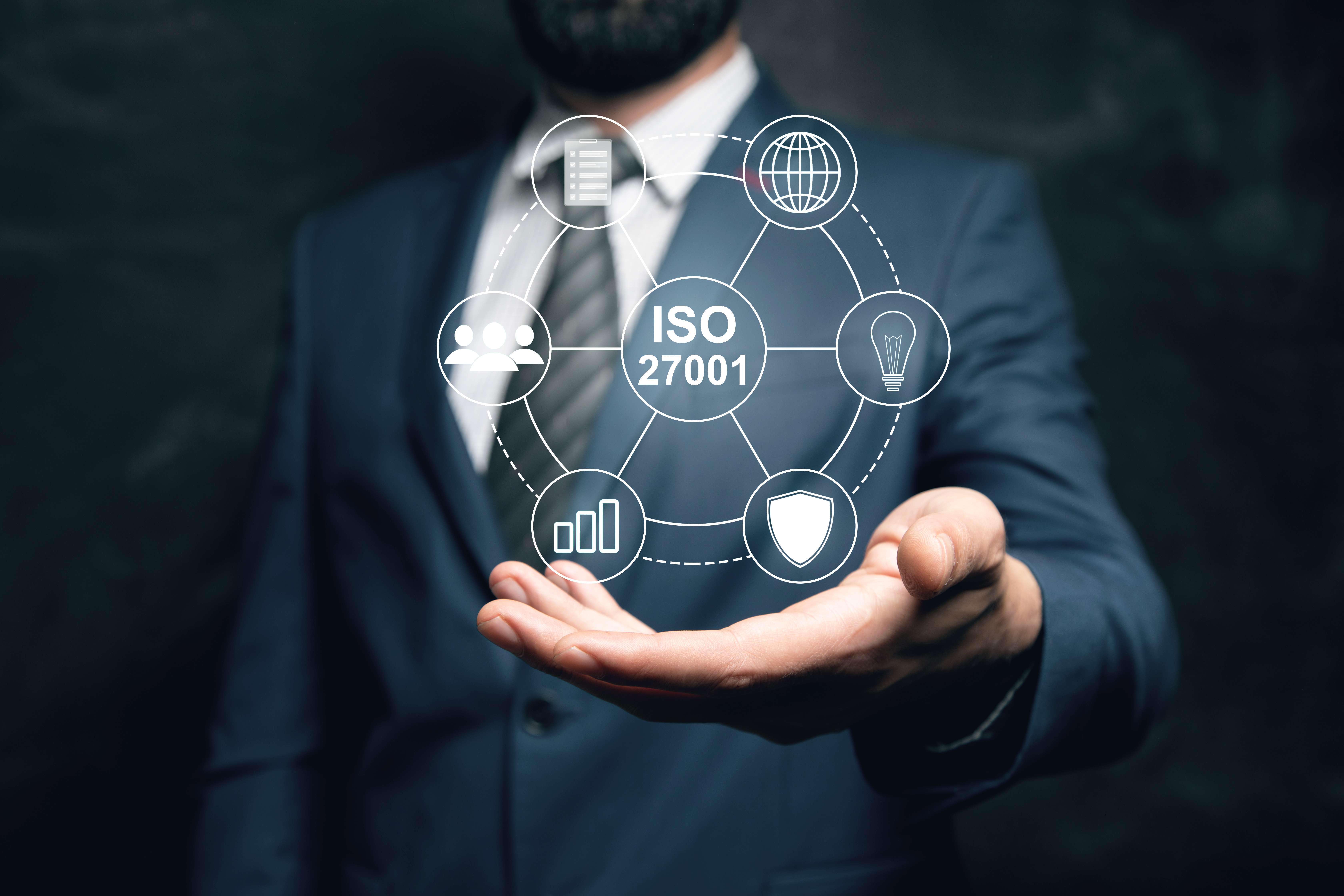ISO 27001 quality and information security management system, held up on a tablet